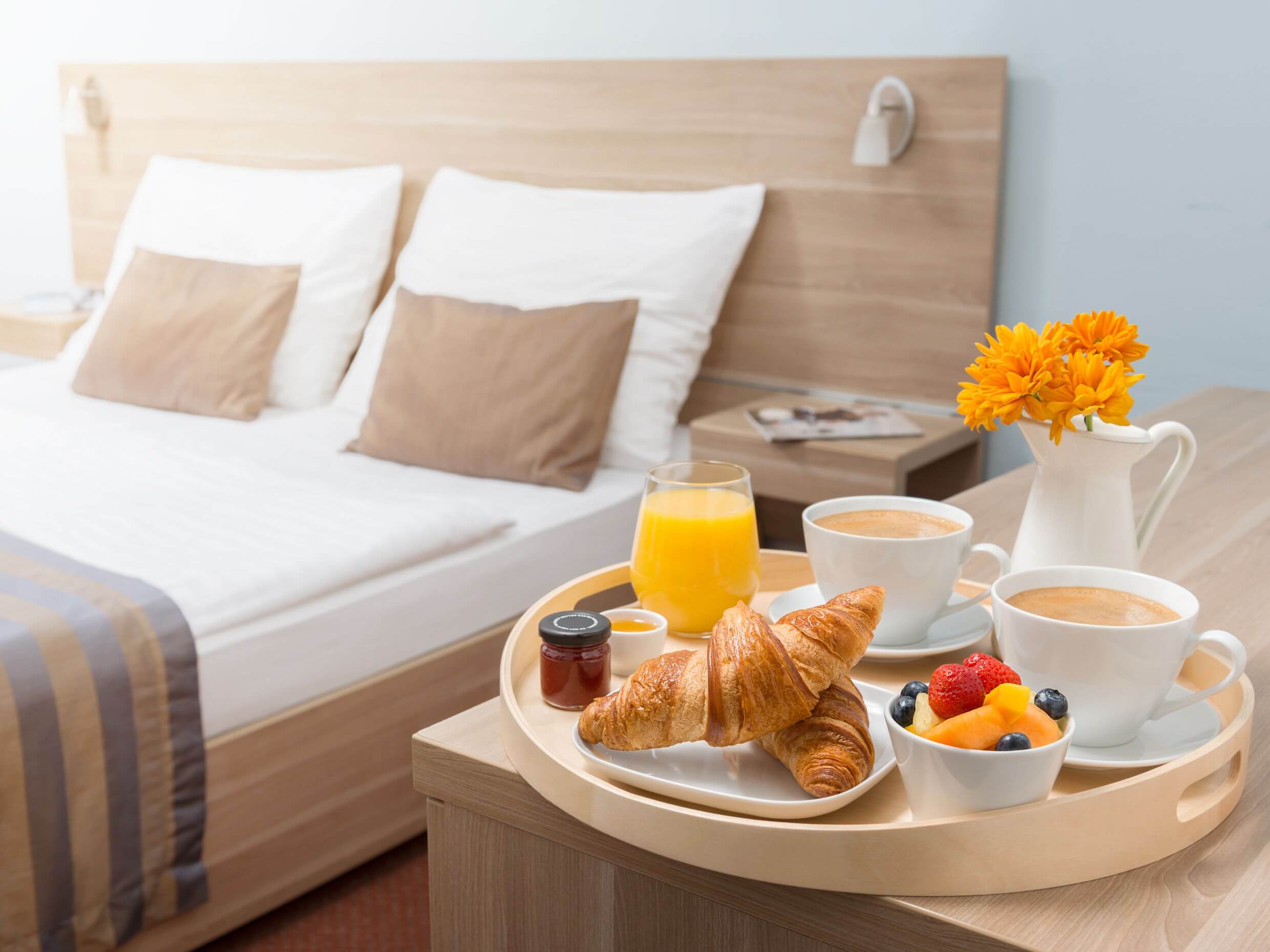 hotel room with breakfast laid out as an experience managed by a hospitality business manager.